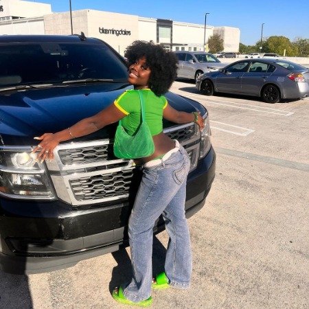 Alijan Kai Haggins posing with her luxurious car. 